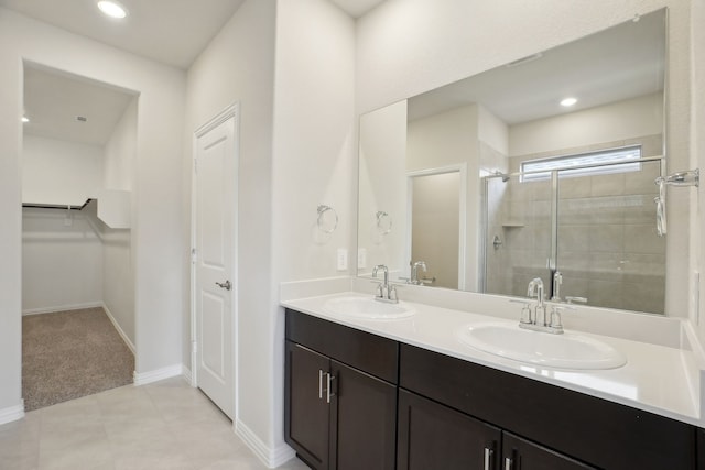 511 Willet Dr, Mckinney, TX 75069 - full bathroom featuring a stall shower, double vanity, a walk in closet, baseboards, and recessed lighting