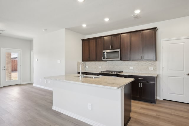 511 Willet Dr, Mckinney, TX 75069 - kitchen with stainless steel appliances, a sink, decorative backsplash, light wood-style floors, and recessed lighting