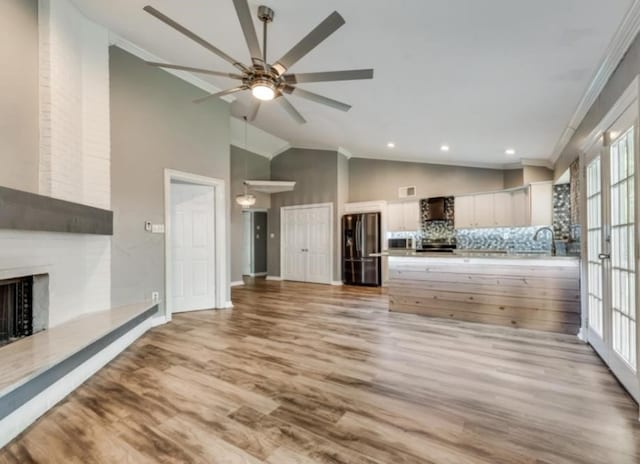 510 Redbud Dr, Forney, TX 75126 - unfurnished living room with a fireplace, crown molding, ceiling fan, wood finished floors, and high vaulted ceiling