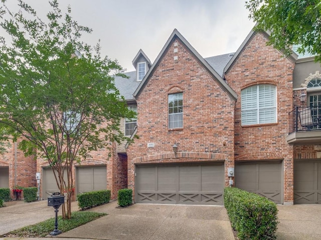 4138 Towne Green Cir, Addison, TX 75001 - view of front of house with driveway, an attached garage, and brick siding