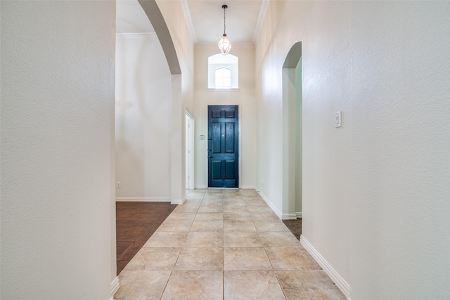 7611 Forest Ridge Trl, Sachse, TX 75048 - entrance foyer with arched walkways, crown molding, baseboards, and a textured wall