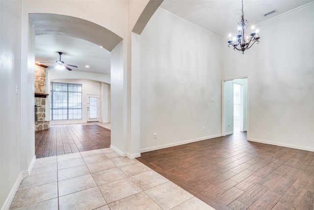 7611 Forest Ridge Trl, Sachse, TX 75048 - unfurnished room featuring a ceiling fan, arched walkways, a chandelier, wood finished floors, and baseboards