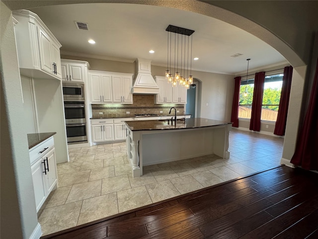 2802 Castlereach St, Trophy Club, TX 76262 - kitchen with custom exhaust hood, stainless steel appliances, a sink, crown molding, and decorative backsplash