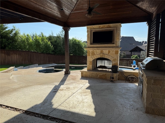 2802 Castlereach St, Trophy Club, TX 76262 - fenced backyard with an outdoor stone fireplace, a patio area, and a ceiling fan