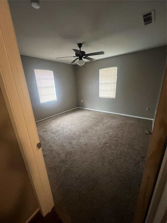 101 Oakland Dr, Lacy Lakeview, TX 76705 - unfurnished room featuring carpet floors, baseboards, ceiling fan, and a smoke detector