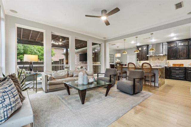 5213 Evening Sun Dr, Frisco, TX 75034 - living room with ceiling fan, light wood-style floors, and crown molding