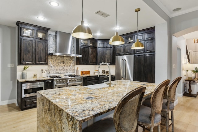 5213 Evening Sun Dr, Frisco, TX 75034 - kitchen featuring wall chimney range hood, high quality appliances, a sink, baseboards, and tasteful backsplash