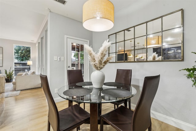 5213 Evening Sun Dr, Frisco, TX 75034 - dining space with baseboards, wood finished floors, and lofted ceiling