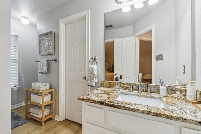 5213 Evening Sun Dr, Frisco, TX 75034 - bathroom with wood finished floors, vanity, and baseboards