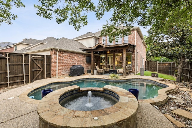 5213 Evening Sun Dr, Frisco, TX 75034 - view of swimming pool featuring a gate, area for grilling, a fenced backyard, a patio, and a pool with connected hot tub