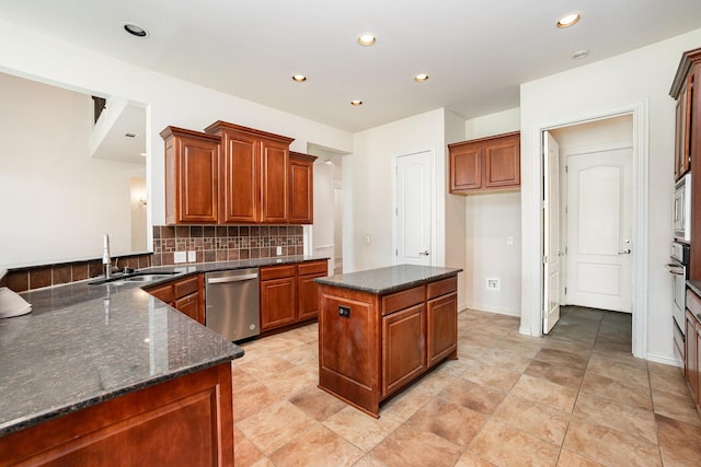 549 Verbena Ln, Frisco, TX 75036 - kitchen with stainless steel appliances, a sink, backsplash, dark stone counters, and recessed lighting