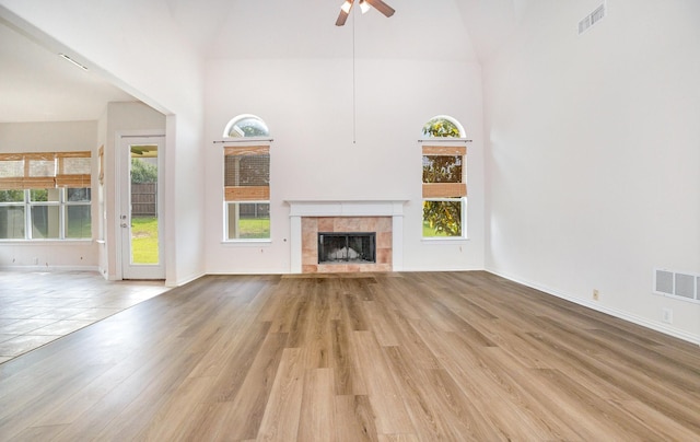 549 Verbena Ln, Frisco, TX 75036 - unfurnished living room with ceiling fan, light wood-type flooring, high vaulted ceiling, a fireplace, and baseboards