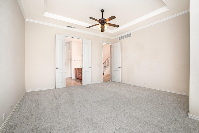 549 Verbena Ln, Frisco, TX 75036 - unfurnished bedroom with a tray ceiling, crown molding, carpet floors, ensuite bath, and baseboards