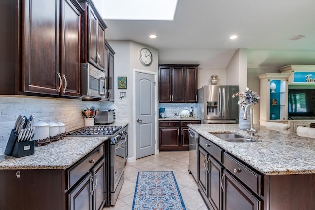 3103 Whispering Pine Blvd, Melissa, TX 75454 - kitchen featuring appliances with stainless steel finishes, a sink, dark brown cabinets, backsplash, and light tile patterned flooring