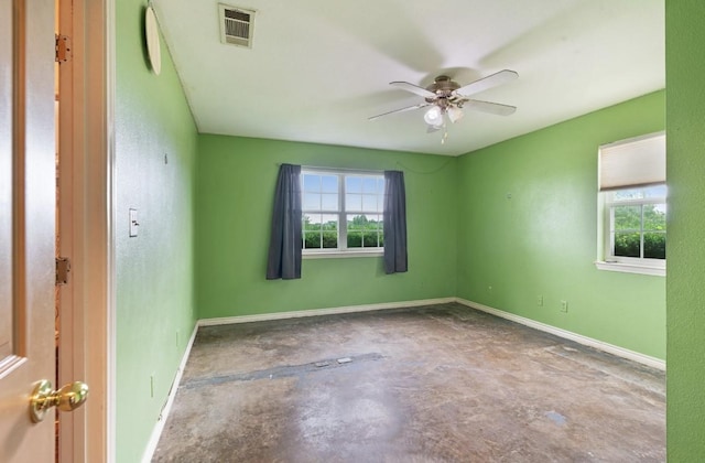1100 County Road 12200, Paris, TX 75462 - spare room featuring unfinished concrete flooring, healthy amount of natural light, ceiling fan, and baseboards
