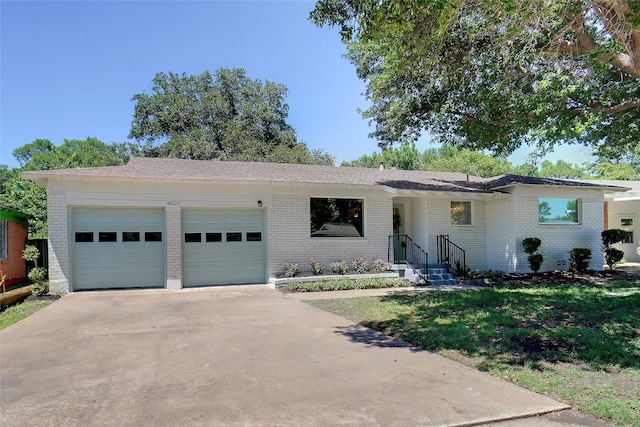 4809 Ira St, Haltom City, TX 76117 - ranch-style home featuring a garage, brick siding, driveway, and a front lawn