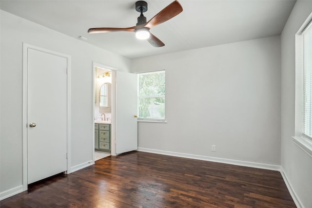 4809 Ira St, Haltom City, TX 76117 - unfurnished bedroom featuring a sink, dark wood-type flooring, baseboards, ensuite bathroom, and ceiling fan