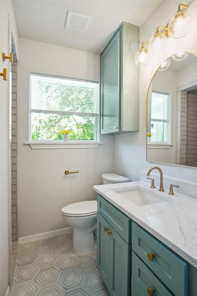 4809 Ira St, Haltom City, TX 76117 - bathroom with toilet, vanity, and baseboards
