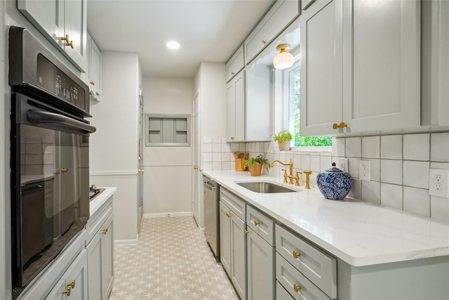 4809 Ira St, Haltom City, TX 76117 - kitchen featuring a sink, oven, tasteful backsplash, stainless steel dishwasher, and light floors