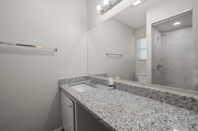 230 NE Craig St, Burleson, TX 76028 - bathroom featuring toilet, tiled shower, and vanity