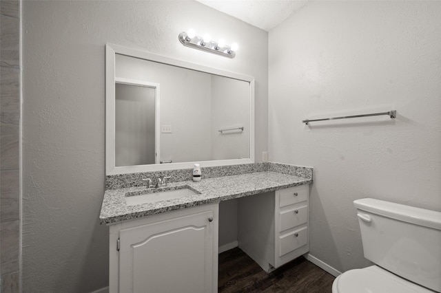 230 NE Craig St, Burleson, TX 76028 - bathroom featuring wood finished floors, vanity, toilet, and baseboards
