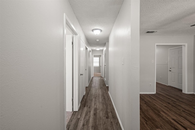 230 NE Craig St, Burleson, TX 76028 - hallway featuring a textured ceiling, dark wood-type flooring, and baseboards