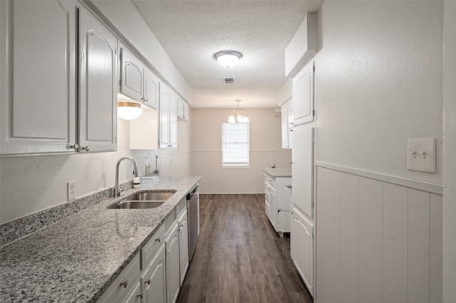 230 NE Craig St, Burleson, TX 76028 - kitchen with a sink, dark wood finished floors, a textured ceiling, dishwasher, and light stone countertops