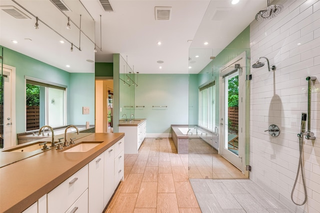 5624 Melshire Dr, Dallas, TX 75230 - full bath featuring a shower stall, a garden tub, two vanities, recessed lighting, and tile patterned flooring