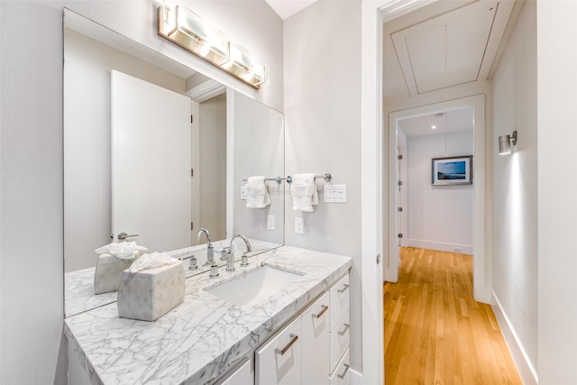 5624 Melshire Dr, Dallas, TX 75230 - bathroom with wood finished floors, vanity, and baseboards