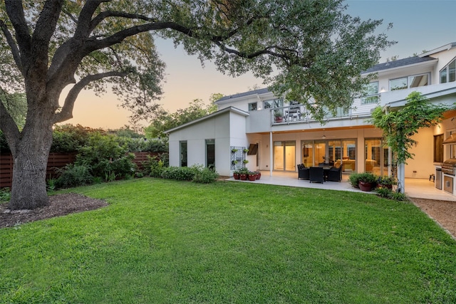 5624 Melshire Dr, Dallas, TX 75230 - back of property at dusk featuring a balcony, a patio area, outdoor lounge area, and stucco siding