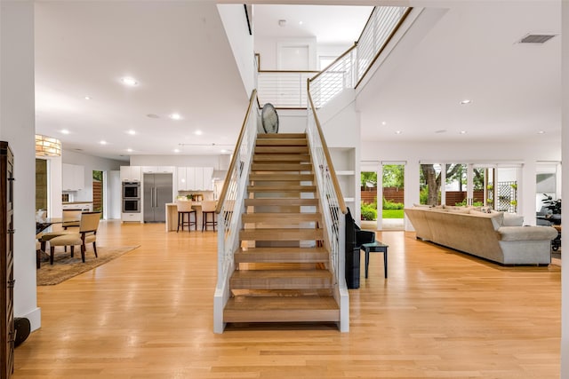 5624 Melshire Dr, Dallas, TX 75230 - stairway with wood finished floors and recessed lighting
