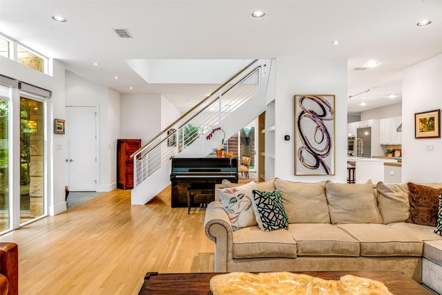 5624 Melshire Dr, Dallas, TX 75230 - living area with light wood-style floors, stairs, and recessed lighting