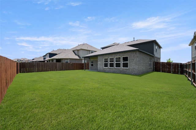 6728 Rockshire, Fort Worth, TX 76123 - back of house with a fenced backyard, brick siding, and roof with shingles