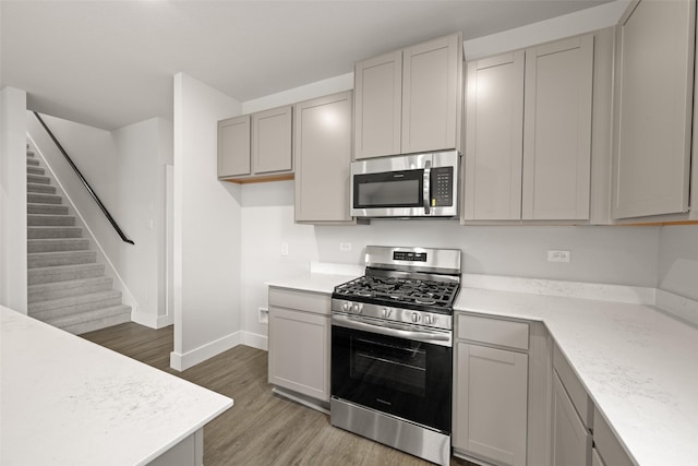 6728 Rockshire, Fort Worth, TX 76123 - kitchen featuring stainless steel appliances, light wood finished floors, and gray cabinets