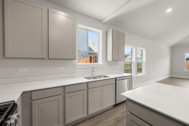 6728 Rockshire, Fort Worth, TX 76123 - kitchen with stainless steel dishwasher, gray cabinetry, light wood-style flooring, gas stove, and lofted ceiling