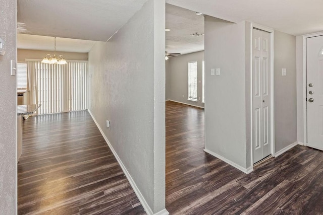2031 Kings Rd, Carrollton, TX 75007 - corridor with wood finished floors, a chandelier, baseboards, and a textured wall