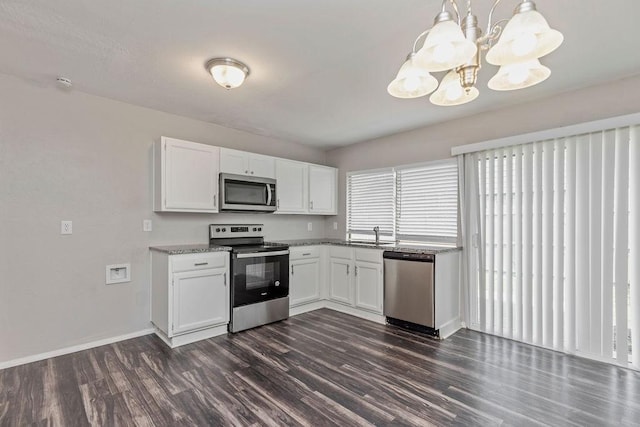 2031 Kings Rd, Carrollton, TX 75007 - kitchen with appliances with stainless steel finishes, dark wood-type flooring, white cabinets, a chandelier, and baseboards