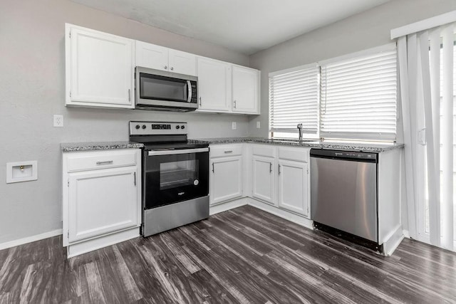 2031 Kings Rd, Carrollton, TX 75007 - kitchen with stainless steel appliances, a sink, white cabinets, and dark wood-style floors