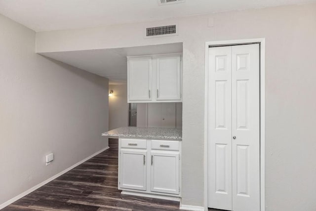 2031 Kings Rd, Carrollton, TX 75007 - kitchen featuring white cabinets, dark wood-type flooring, light countertops, and baseboards