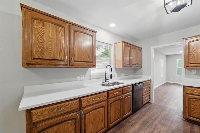 1625 Walnut St, Grand Prairie, TX 75050 - kitchen featuring a sink, stainless steel dishwasher, dark wood finished floors, light countertops, and plenty of natural light