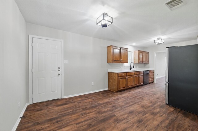 1625 Walnut St, Grand Prairie, TX 75050 - kitchen featuring freestanding refrigerator, dishwasher, light countertops, a sink, and baseboards
