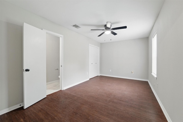1625 Walnut St, Grand Prairie, TX 75050 - unfurnished bedroom with wood finished floors, multiple windows, baseboards, and a ceiling fan