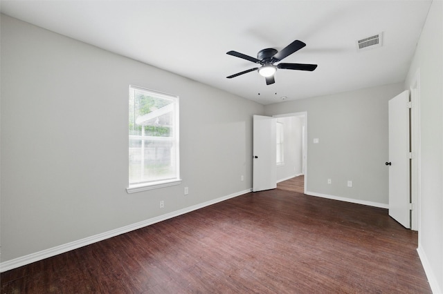 1625 Walnut St, Grand Prairie, TX 75050 - unfurnished bedroom featuring baseboards, dark wood-style floors, and a ceiling fan