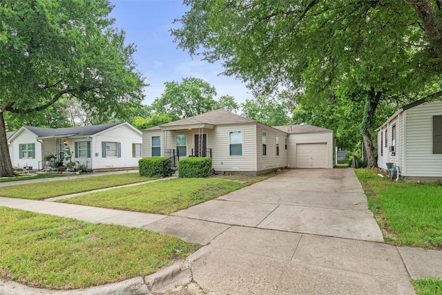 1625 Walnut St, Grand Prairie, TX 75050 - view of front of home with concrete driveway, a garage, and a front lawn