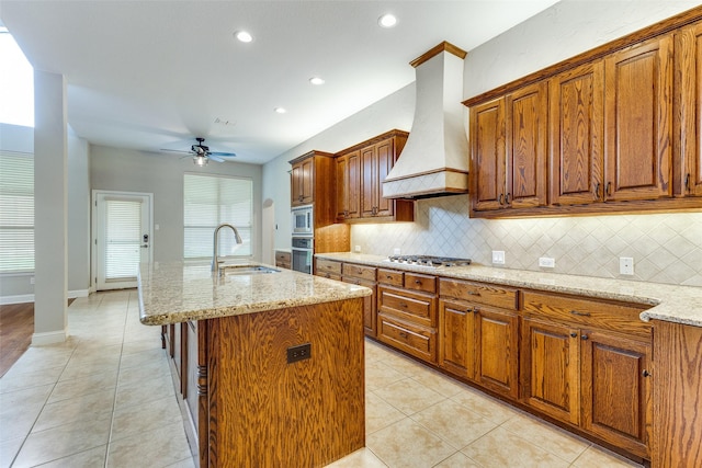 225 Tipperary Dr, Keller, TX 76248 - kitchen featuring a sink, stainless steel appliances, a ceiling fan, decorative backsplash, and custom range hood