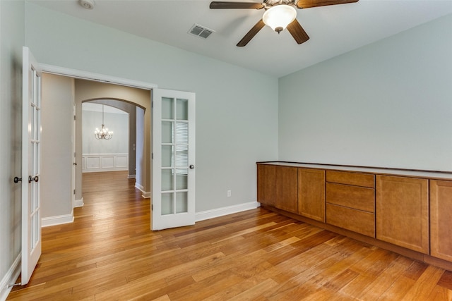 225 Tipperary Dr, Keller, TX 76248 - spare room with arched walkways, light wood-style floors, a ceiling fan, and baseboards