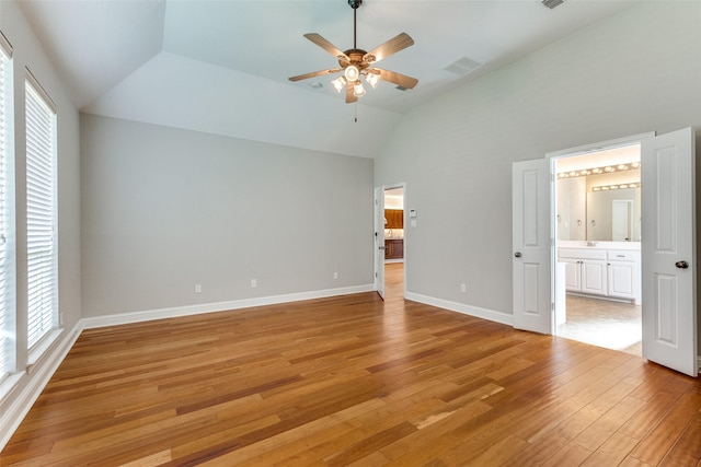 225 Tipperary Dr, Keller, TX 76248 - unfurnished bedroom featuring lofted ceiling, multiple windows, light wood finished floors, and connected bathroom