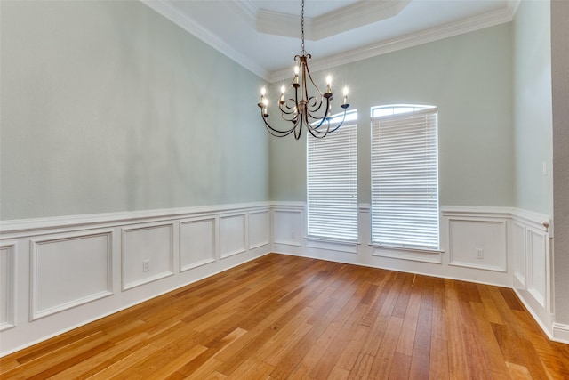 225 Tipperary Dr, Keller, TX 76248 - spare room featuring a chandelier, light wood-style floors, crown molding, a wainscoted wall, and a raised ceiling