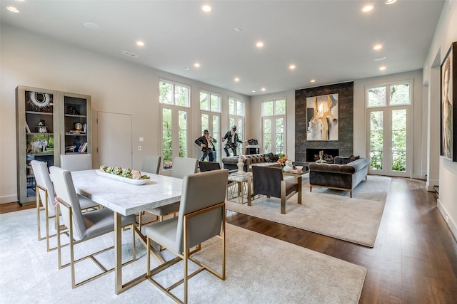 4678 Christopher Pl, Dallas, TX 75204 - dining room with plenty of natural light, recessed lighting, wood finished floors, and a large fireplace