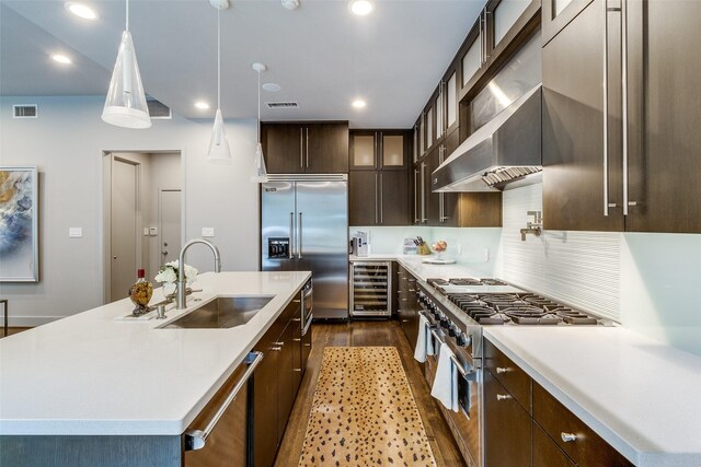 4678 Christopher Pl, Dallas, TX 75204 - kitchen featuring wine cooler, a sink, high end appliances, dark wood-type flooring, and dark brown cabinetry